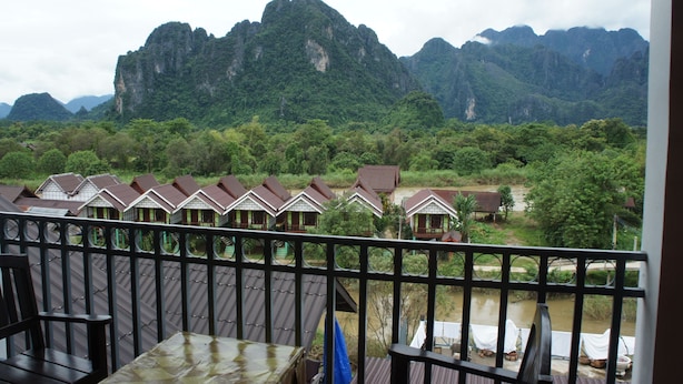 A view of a mountainous landscape with a row of houses in the foreground.
