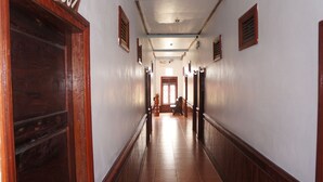 A long, narrow hallway with wooden doors and a number "307" on the left.