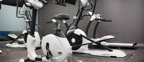A gym with stationary bikes and treadmills.