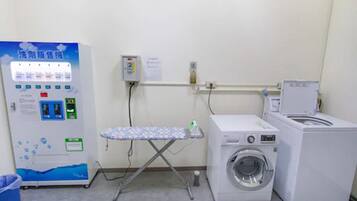 A laundry area with a washing machine, dryer, and a water dispenser.