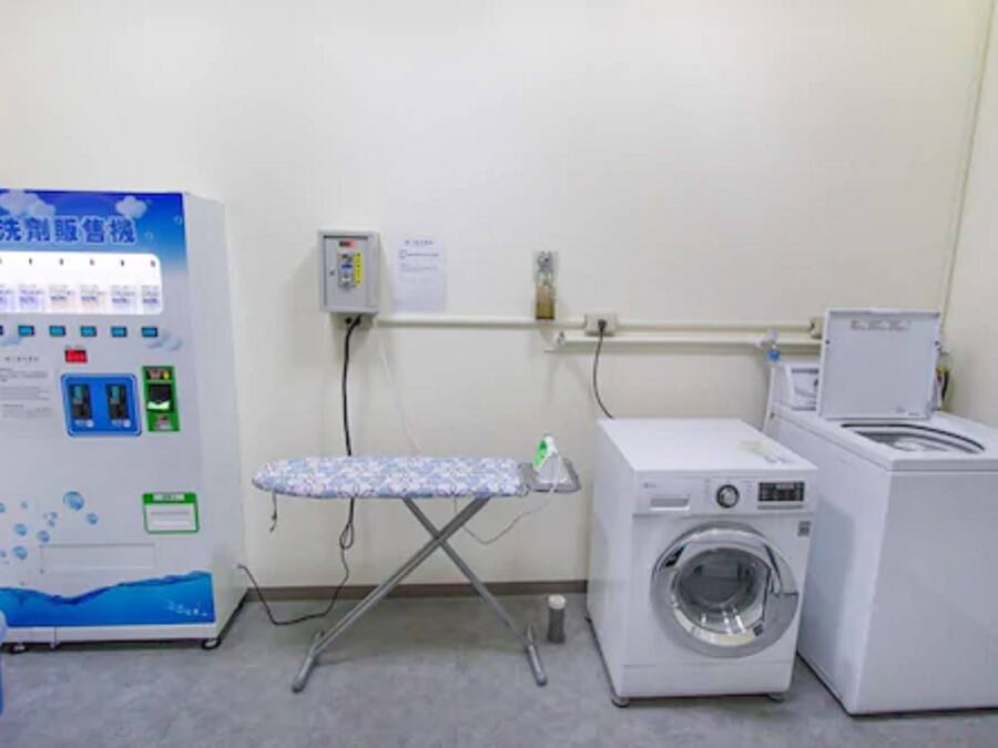 A laundry area with a washing machine, dryer, and a water dispenser.
