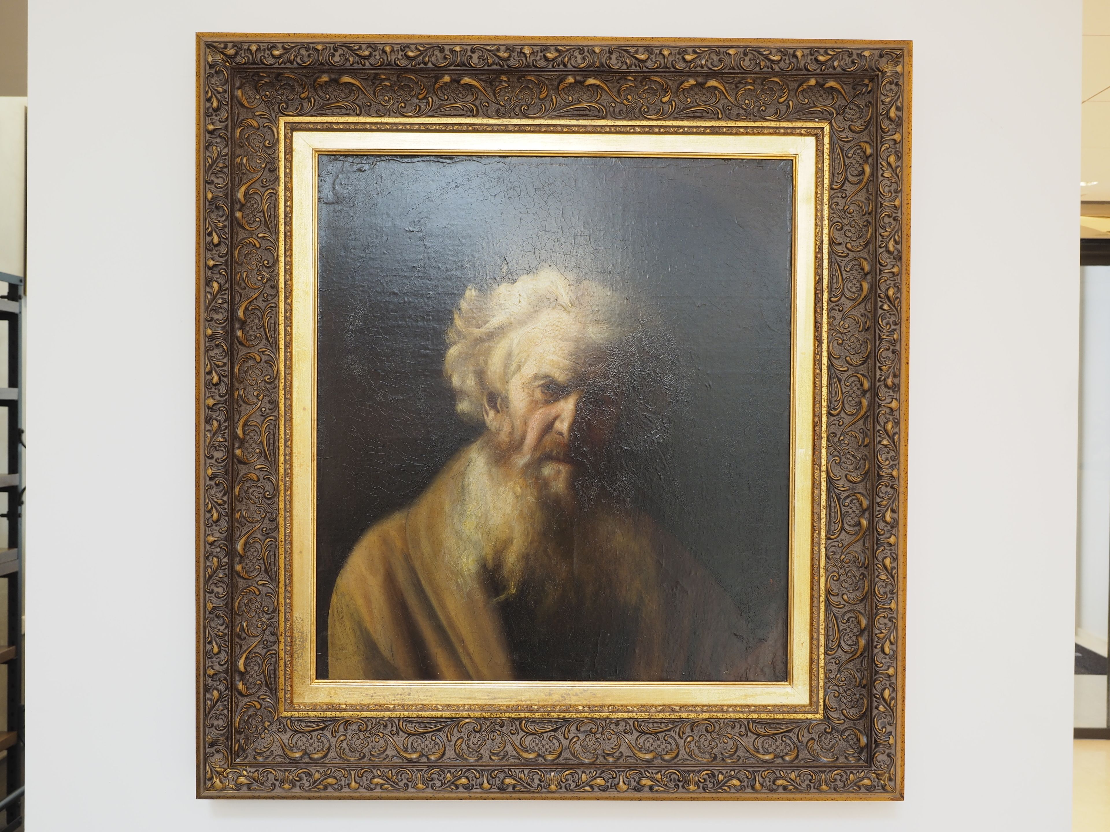 Une œuvre d’art encadrée, dotée d’une bordure richement décorée et très travaillée.