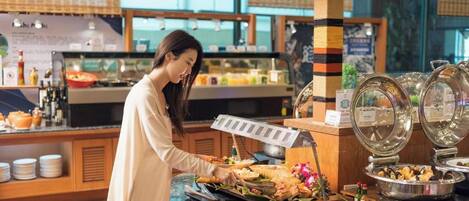 A buffet setup with various food items and a buffet station.