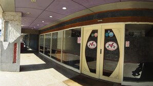 A hallway with a series of doors, each marked with a hotel logo and a no smoking sign. - Taoyuan Hua Yue Hotel (Taoyuan City)