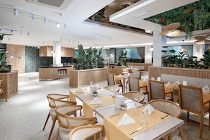 A modern restaurant with wooden furniture, a central bar, and indoor plants. - Annabella Park Hotel (Alanya)