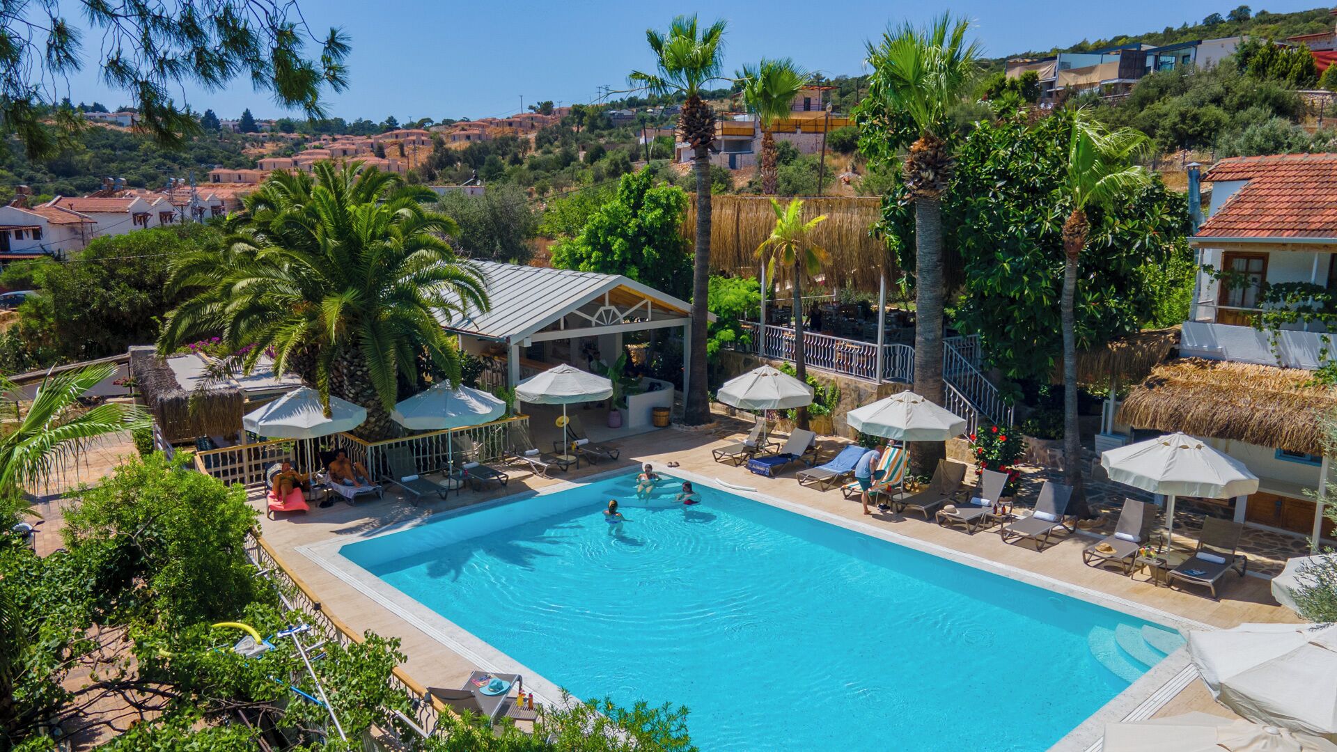 outdoor pool, open 9 am to 7 pm, pool umbrellas, pool loungers