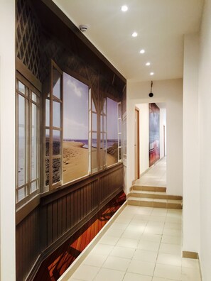 Stunning beach views from the hallway, with a staircase leading to another level.