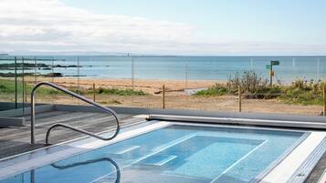 A swimming pool with a view of the beach and ocean.