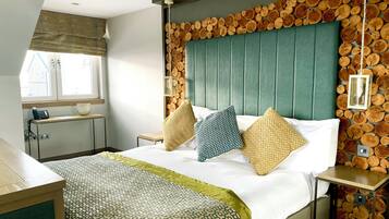 A hotel room with a bed, a bedside table, a lamp, and a window with a view.