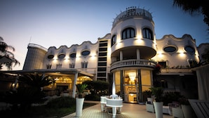 A modern hotel with a unique architectural design, featuring circular windows and balconies. - Hotel Imperiale (Terzigno)