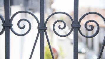 A close-up of a metal railing with decorative scrollwork.