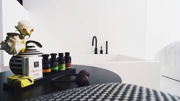 A bathroom with a black and white striped vase, a bottle of shower cap, and a bottle of hair collection.