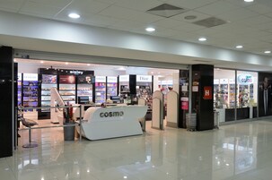 Una tienda moderna con un llamativo rótulo 'cosmo', que presenta marcas como Sisley, Clinique, Dior y H&M.
