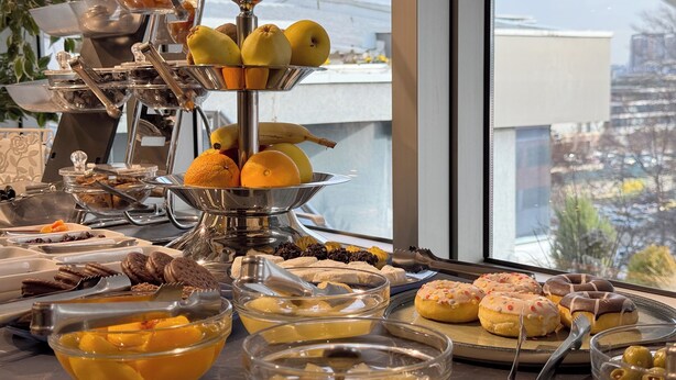A buffet with various fruits, pastries, and desserts. - Queen's Hotel (Skopje)