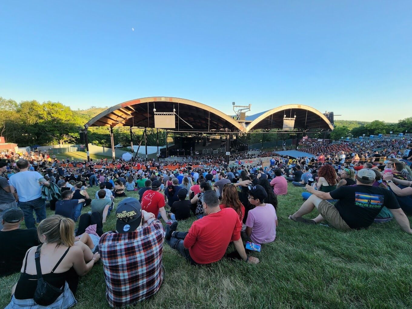 An outdoor amphitheater with tiered seating and a stage.