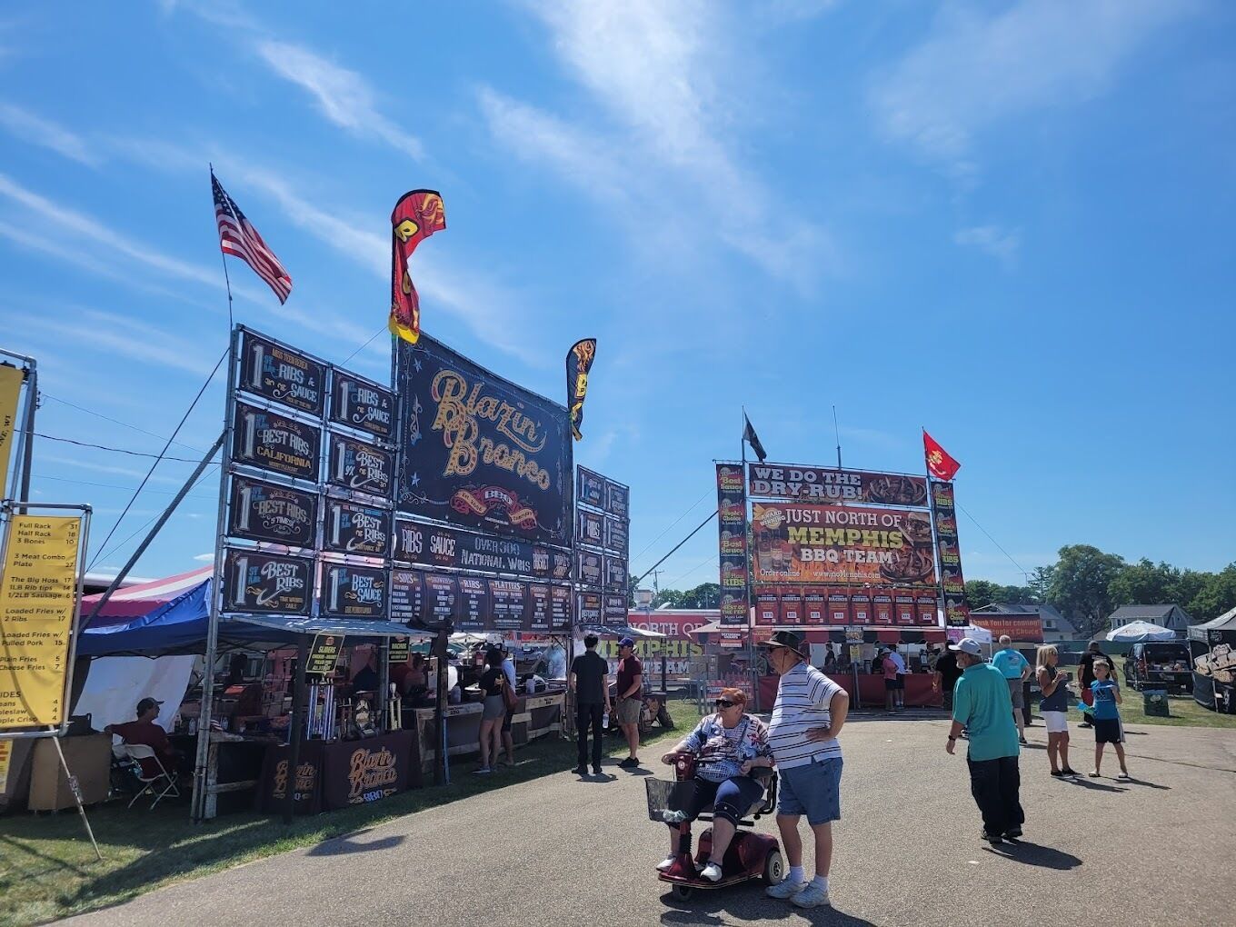 A food court with multiple food stalls and a large sign advertising a BBQ team.