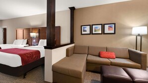 A hotel room with a bed, a sofa, a chair, and a desk. There are three framed pictures on the wall. - Comfort Suites Kanab National Park Area (Kanab)