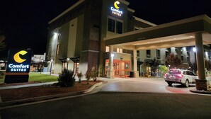 A Comfort Suites hotel at night with a well-lit entrance, a parking area, and a clear view of the building's exterior. - Comfort Suites Kanab National Park Area (Kanab)