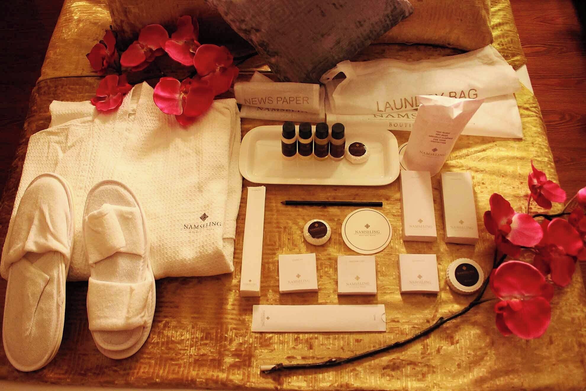 A neatly arranged set of toiletries and a pair of slippers on a wooden surface.