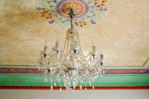 A chandelier with multiple arms and crystal decorations.