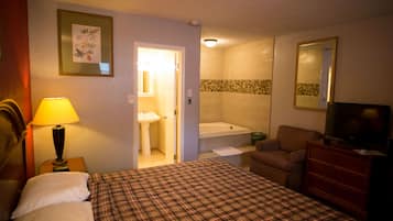 Suite, 1 King Bed, Jetted Tub | Desk, blackout drapes, iron/ironing board, rollaway beds