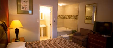Suite, 1 King Bed, Jetted Tub | Desk, blackout curtains, iron/ironing board, rollaway beds
