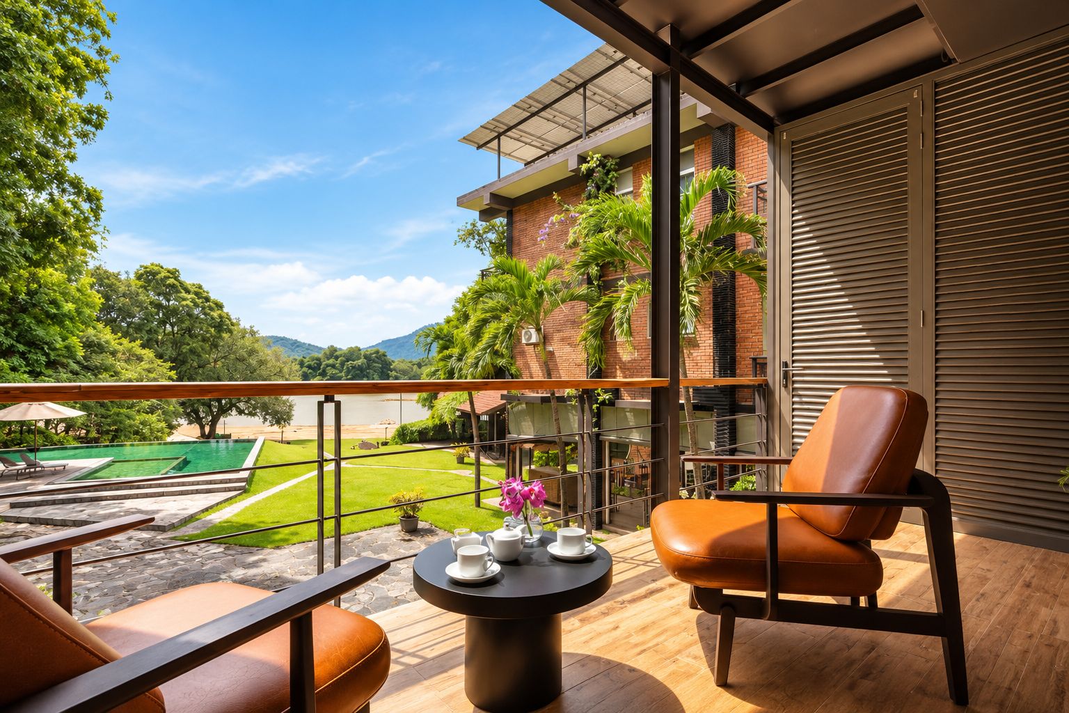 A balcony with a view of a swimming pool, a table with cups, and a chair.