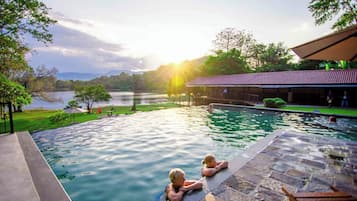 Outdoor pool, open 6:30 AM to 8:00 PM, pool umbrellas