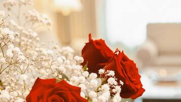 A bouquet of red roses and white baby's breath flowers.