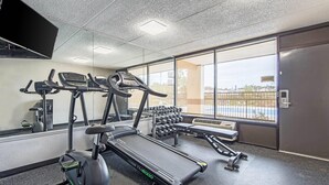 A gym with treadmills, dumbbells, and a bench. - Quality Inn Forest City (Forest City)