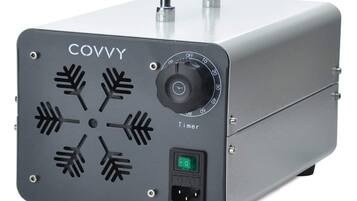 A gray portable heater with a timer dial, a power switch, and a digital display.