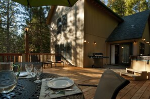 A wooden deck with outdoor seating, a grill, and a hot tub. - Yosemite Scenic Wonders - Wawona Area (Yosemite National Park)