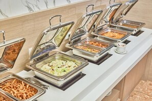 A buffet line with various food options in metal containers. - Naruwan Inn (Taitung)