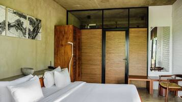 A modern bedroom with a large bed, wooden wardrobe, and a desk with a chair.
