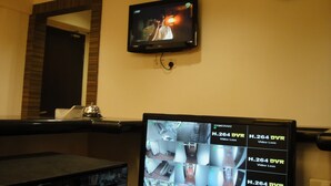 A hotel room with a television mounted on the wall, a clock, and a security camera display. - 1 Hotel Pudu Cheras (Kuala Lumpur)