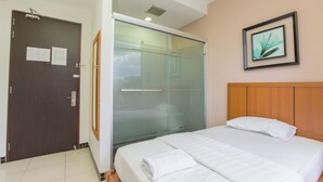 A hotel room with a bed, a glass shower enclosure, a wooden headboard, and a framed picture on the wall. - 1 Hotel Pudu Cheras (Kuala Lumpur)