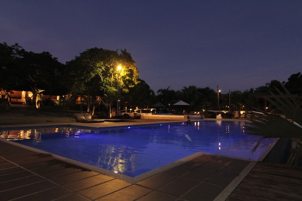 Outdoor pool, an infinity pool, pool umbrellas, pool loungers