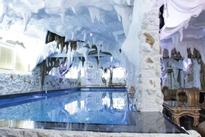 An indoor pool with ice formations and stone walls. - Bali Colosseum Hotel (Belgrade)