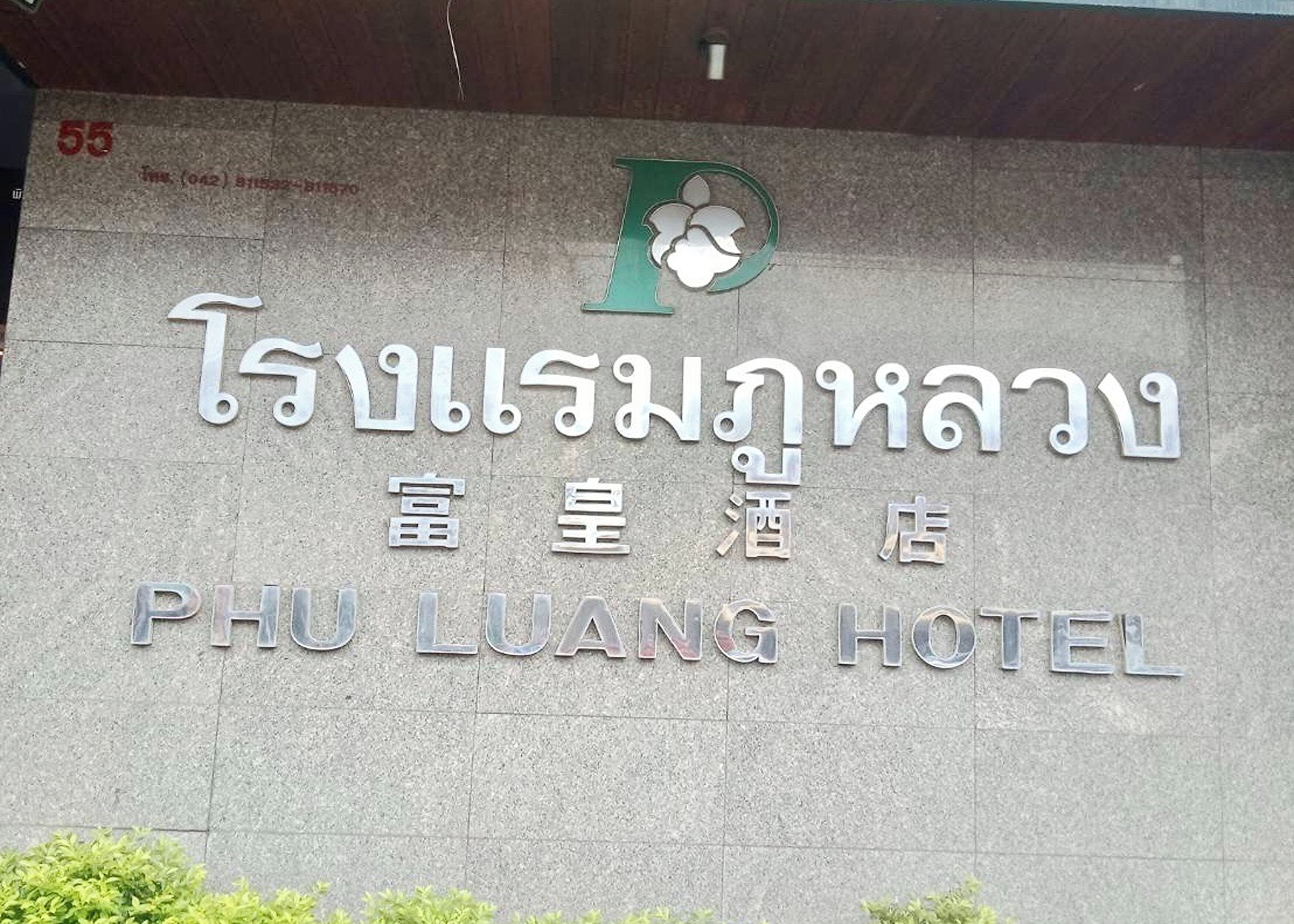 A sign for the Phu Luang Hotel with Thai and English text, indicating its name and location.