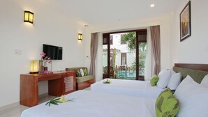 A hotel room with two beds, a desk, a TV, and a view of the pool. - Green Boutique Villa (Da Nang)