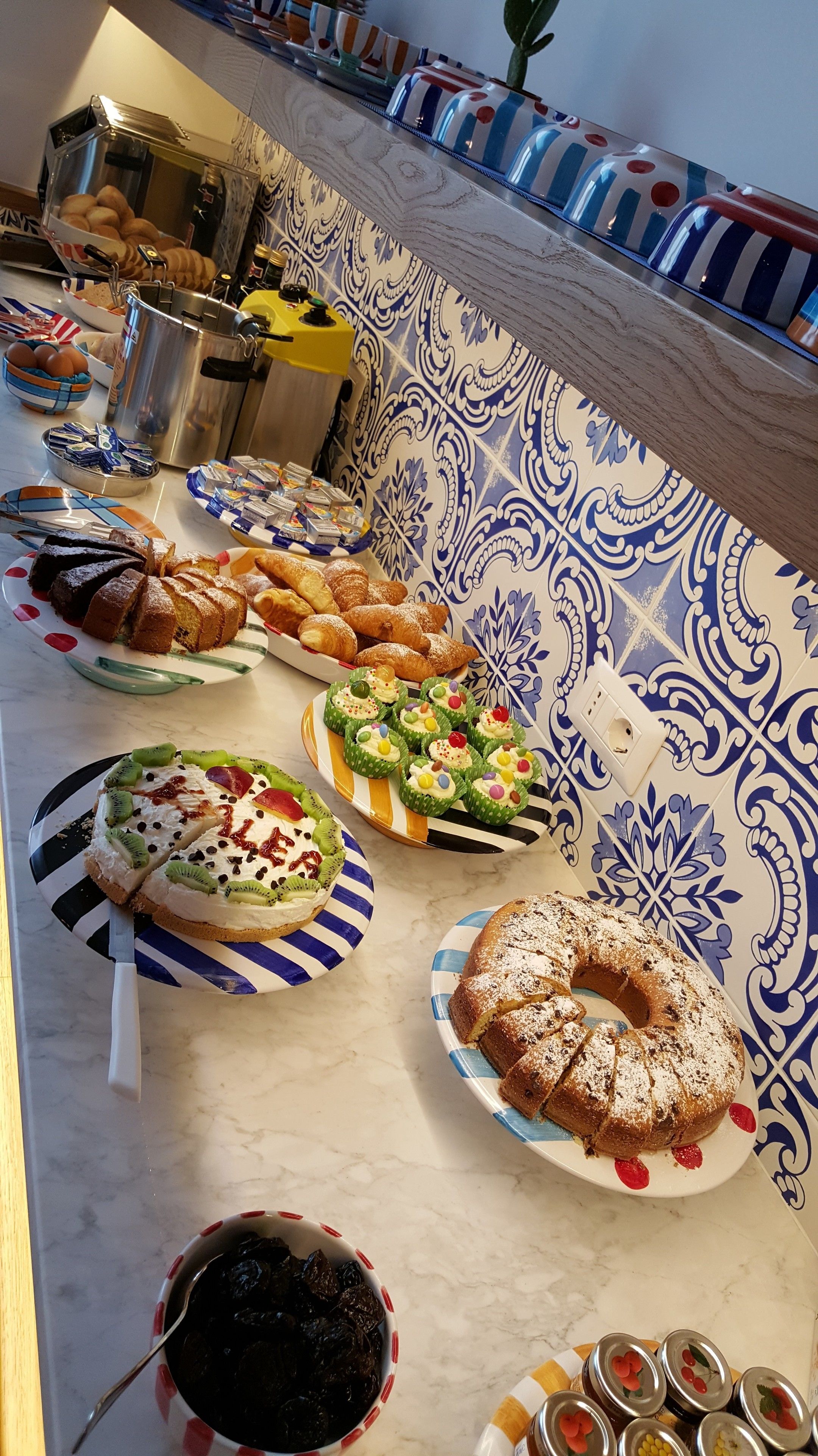 Buffet com diversos alimentos, incluindo doces, bolos e sobremesas.