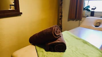 Relax in this cozy retreat with a comfortable bed, a window offering a serene view of the surrounding flowers and a deer decoration.