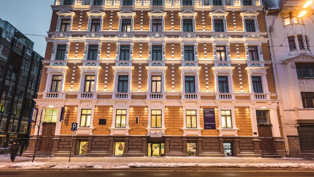 A multi-story building with a classic architectural style, featuring ornate balconies and large windows. - Bearsleys Downtown Apartments (Riga)