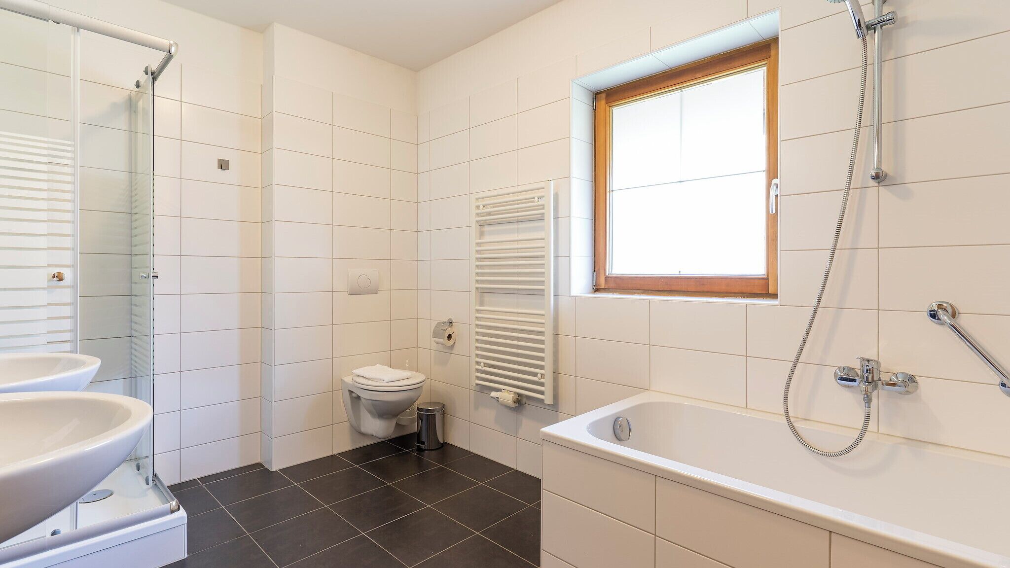 A bathroom with a bathtub, a toilet, and a shower.