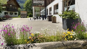 A building with a sign for 'Obertraun Restaurant' and a chessboard in the foreground. - Dormio Resort Obertraun (Obertraun)