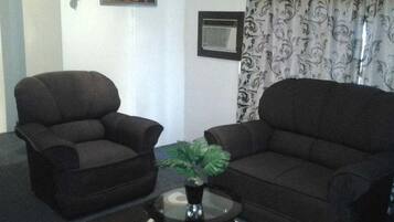 Deluxe Apartment, 1 Bedroom | Living room | Flat-screen TV, DVD player