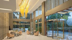 A spacious lobby with modern furniture, large windows, and a distinctive chandelier. - Renaissance Lucknow Hotel (Lucknow)