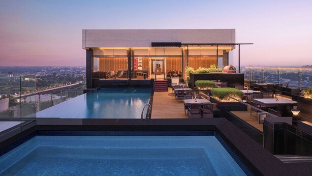 A rooftop pool with a city view, a bar, and outdoor seating. - Renaissance Lucknow Hotel (Lucknow)