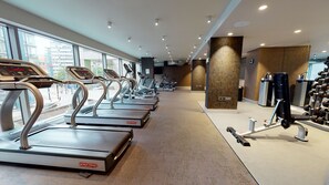 A gym with treadmills, elliptical machines, and weightlifting equipment. - Holiday Inn Manchester - City Centre by IHG (Manchester)