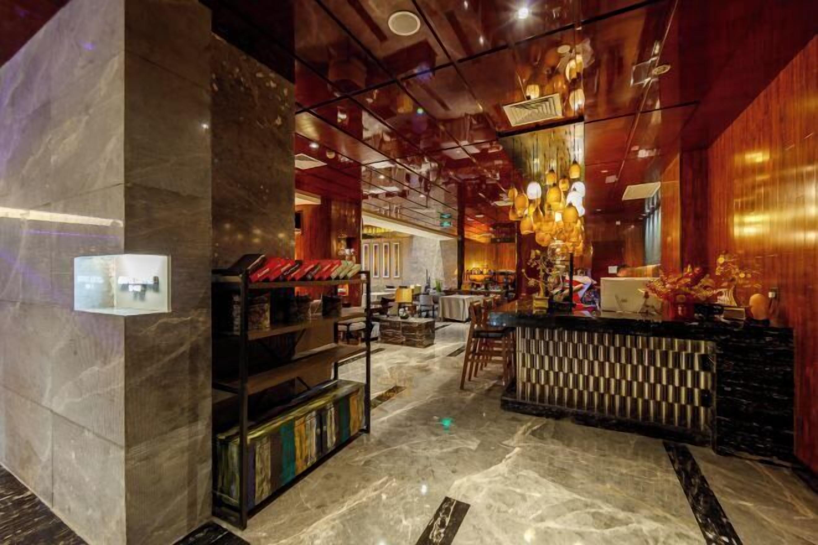 A modern interior with a bar area, marble flooring, and wooden accents.